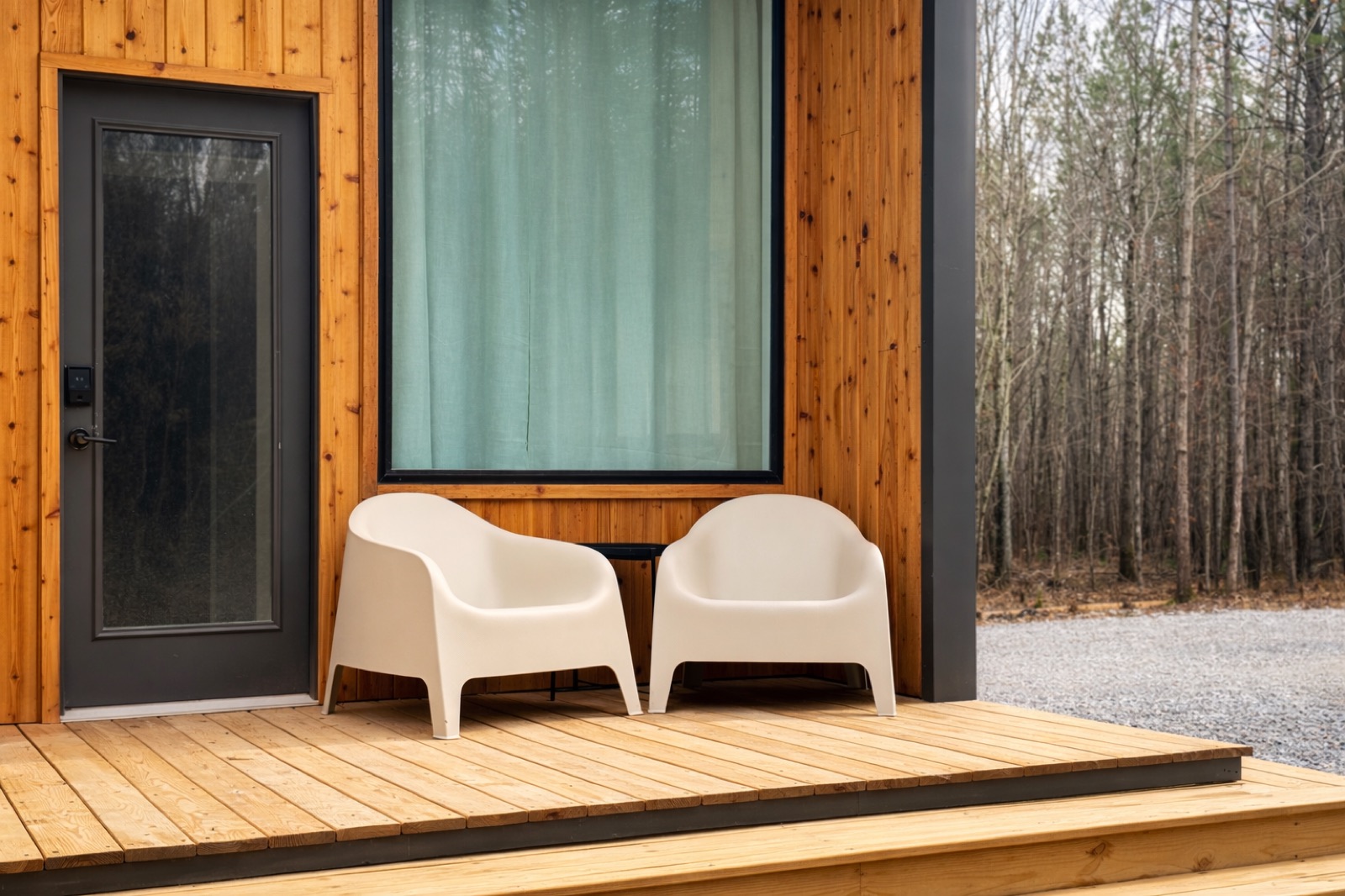 Cabin exterior with chairs on the front porch